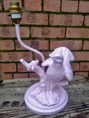 Vintage ceramic bird on a branch lamp base revamped using pink spray paint